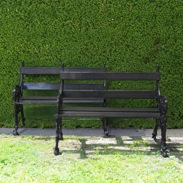 POSSIBLY FALKIRK; A PAIR OF BLACK PAINTED METAL FOLIATE CAST GARDEN BENCHES (2)