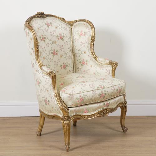 A LOUIS XV STYLE GILT FRAMED WINGBACK ARMCHAIR