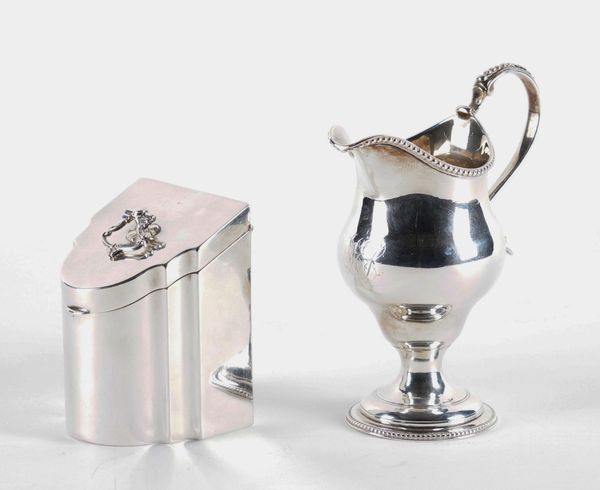 A SILVER TEA CADDY AND A SILVER CREAM JUG (2)