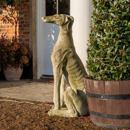 A PAIR OF STONE EFFECT FIGURES OF SEATED GREYHOUNDS (2)