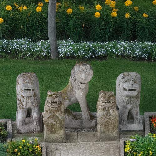 A PAIR OF EASTERN STYLE RECONSTITUTED STONE SEATED TEMPLE DOGS (5)