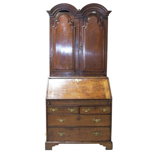 AN EARLY 18TH CENTURY OAK DOUBLE DOME TOP BURAEU BOOKCASE