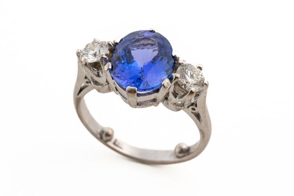 A TANZANITE AND DIAMOND THREE STONE RING