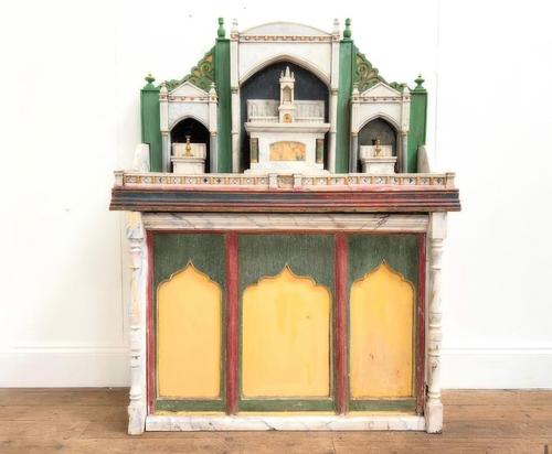 A POLYCHROME WOOD AND MARBLE MOUNTED SMALL ALTARPIECE ON A FAUX MARBLE BASE