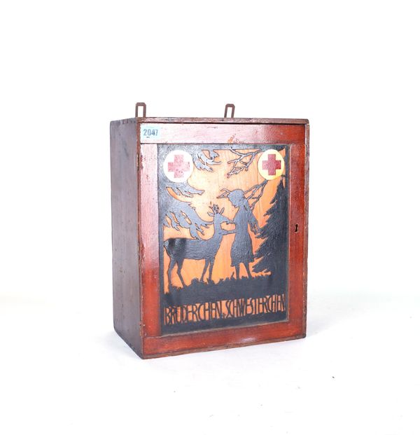 A MID 20TH CENTURY CONTINENTAL FOLK ART WOODEN FIRST AID CABINET