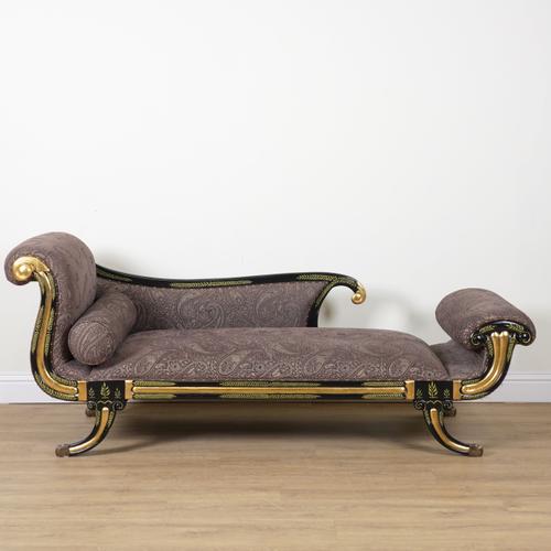A REGENCY STYLE EBONISED AND PARCEL GILT DECORATED CHAISE LONGUE