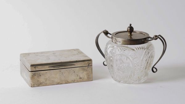 A SILVER RECTANGULAR TABLE CIGARETTE BOX AND A SILVER MOUNTED FACETED GLASS PRESERVE JAR AND COVER (2)