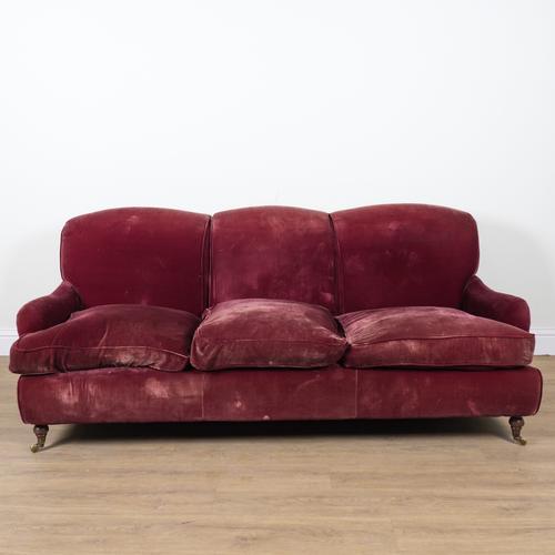A MODERN ROUGE VELVET UPHOLSTERED TRIPLE HUMP BACK SOFA