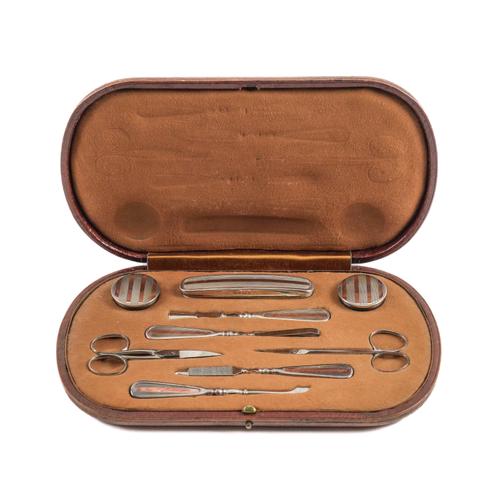 A SILVER AND GILT MOUNTED LADY'S MANICURE SET