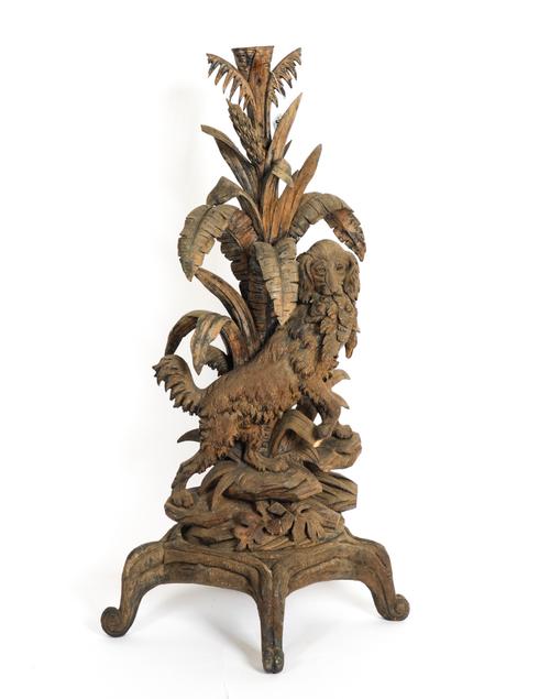 A BLACK FOREST CARVED LINDEN WOOD RETRIEVER DOG SCULPTURE