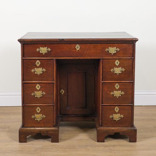 A GEORGE II OAK KNEEHOLE WRITING DESK