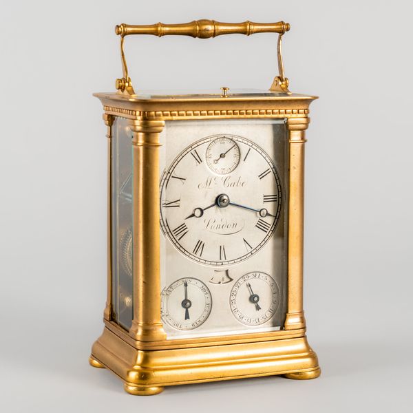 AN UNUSUAL FRENCH GILT METAL CALENDAR STRIKING CARRIAGE CLOCK WITH SKELETONISED LEVER ESCAPEMENT