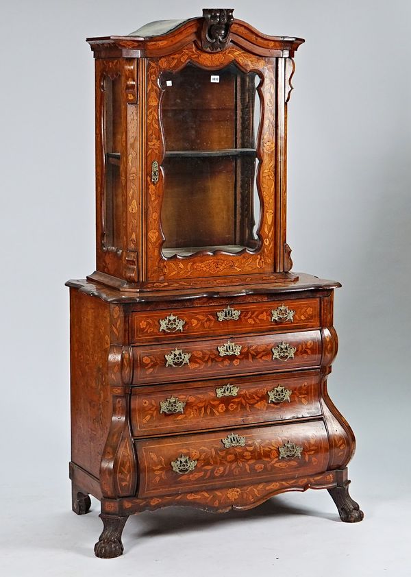 A late 18th century Dutch floral marquetry inlaid walnut display cabinet commode, the top section with single glazed door over a bombe four drawer base on...