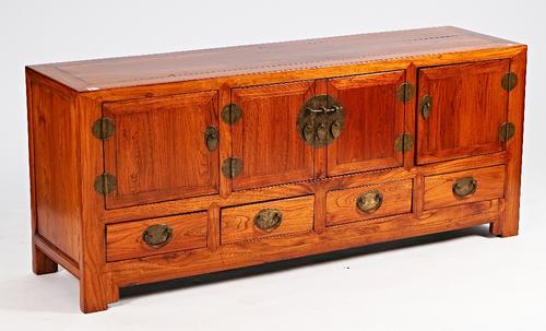 An early 20th century Chinese hardwood low cabinet with four cupboards over drawers on bracket feet, 164cm wide x 68cm high.