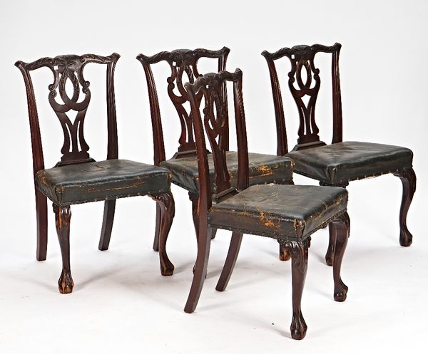 A set of four George III style carved mahogany pierced splat back dining chairs on claw and ball supports, 56cm wide x 95cm high (4).