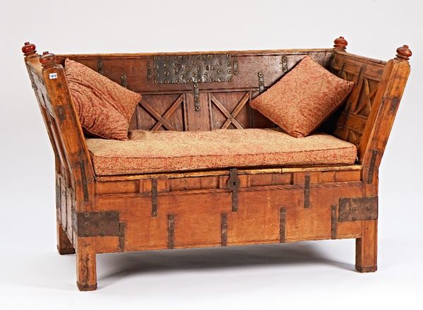 An Indian iron bound teak splayed square back sofa with lift box seat on block supports, 171cm wide x 108cm high.