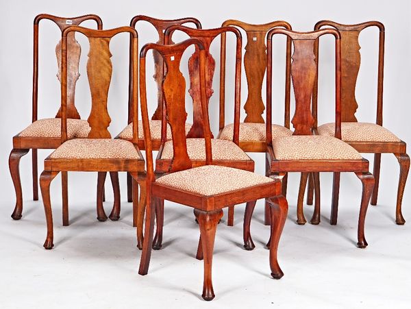 A set of eight Queen Anne revival stained beech vase back dining chairs on cabriole supports, 52cm wide x 104cm high.