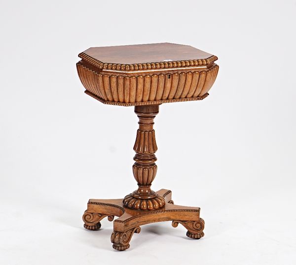 In the manner of Gillows; a Regency rosewood teapoy with twin lidded interior on reeded column and quatrefoil platform, 49cm wide x 72cm high.