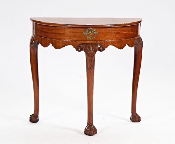 A George II style demi-lune side table with lift top on three claw and ball supports, 77cm wide x 72cm high.