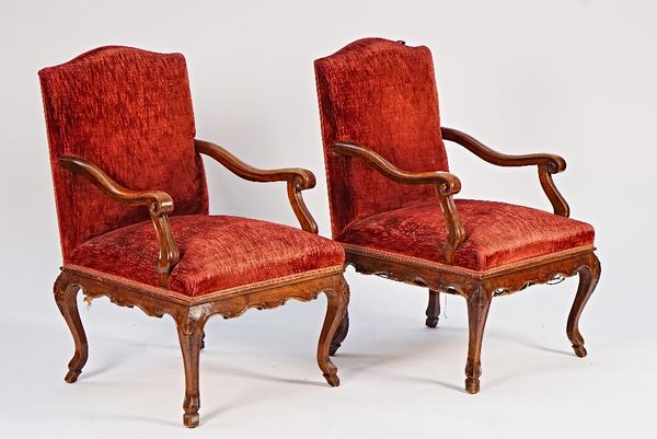 A pair of 19th century French walnut framed open armchairs with shaped frieze on cabriole supports, 62cm wide x 100cm high.