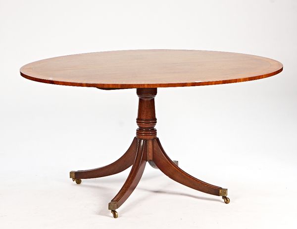 A George III style oval satinwood banded centre table on four downswept supports, 152cm wide x 75cm high.