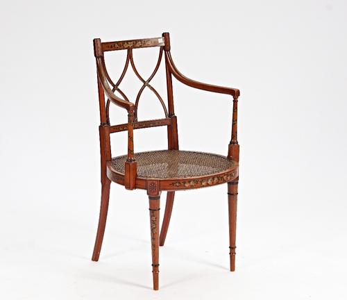 'JAS Shoolbred & Co', a polychrome painted satinwood open armchair with double 'X' splat, 55cm wide x 90cm high.