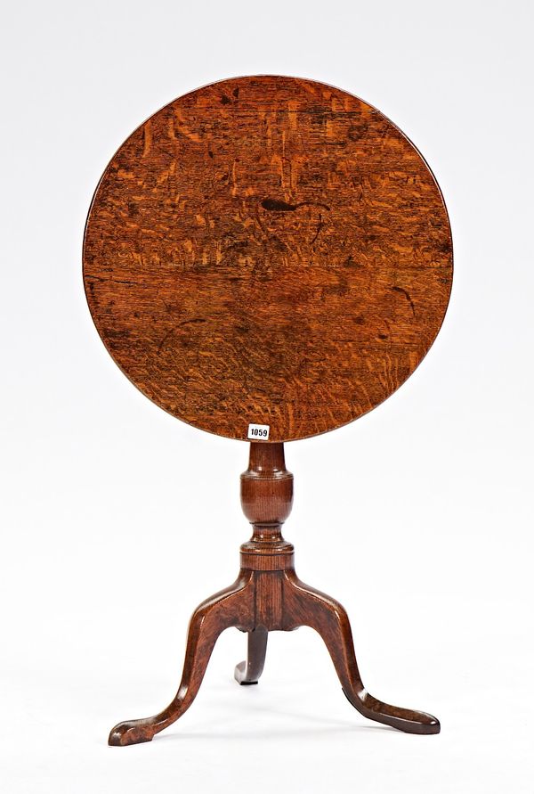 An 18th century oak circular snap top tripod occasional table, 57cm diameter x 69cm high.