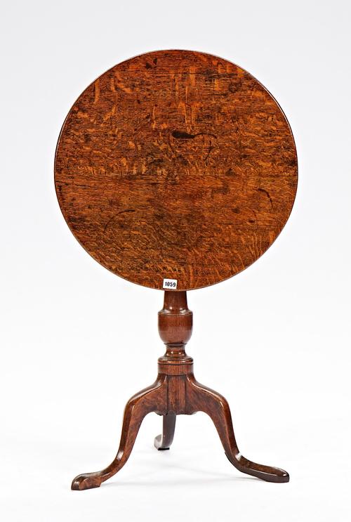 An 18th century oak circular snap top tripod occasional table, 57cm diameter x 69cm high.