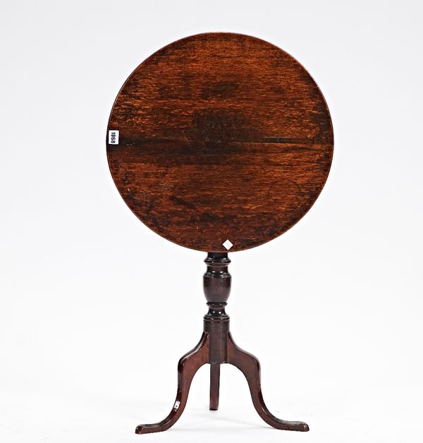 An 18th century oak circular snap top tripod occasional table, 52cm diameter x 64cm high.