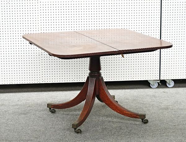 A GEORGE III MAHOGANY RECTANGULAR EXTENDING DINING TABLE