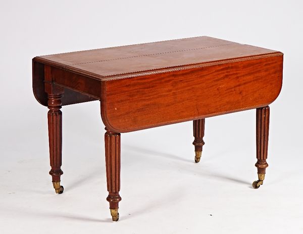 A Regency mahogany drop flap extending dining table on reeded supports, 115cm wide x 114cm long.