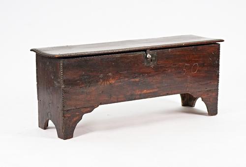 A 17th century oak five plank coffer with chip work decoration on slab end supports, 126cm wide x 51cm high.