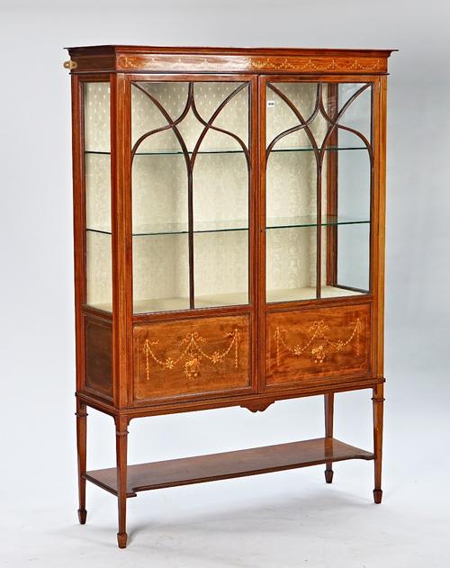 An Edwardian marquetry inlaid mahogany two door display cabinet.