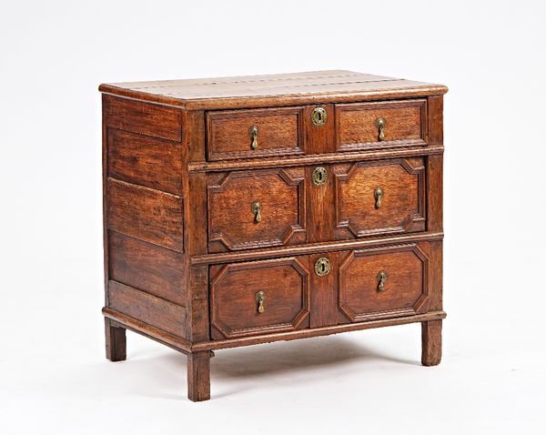 A Charles II oak chest of three long graduated moulded geometric drawers, 79cm wide x 77cm high.