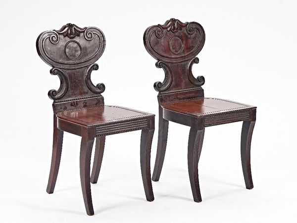 A pair of Regency mahogany hall chairs (2).