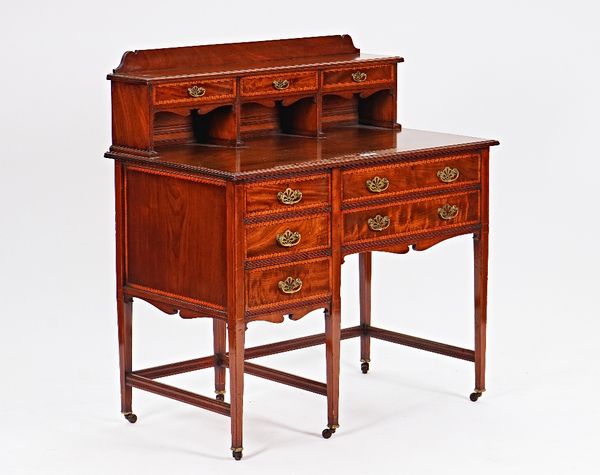 An Edwardian inlaid mahogany writing desk, with fitted three drawer superstructure over five frieze drawers, on tapering square supports, 100cm wide...