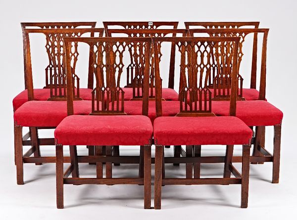 A set of eight George III mahogany dining chairs with pierced Gothic design, with splat backs on canted square supports, 57cm wide x 97cm high.