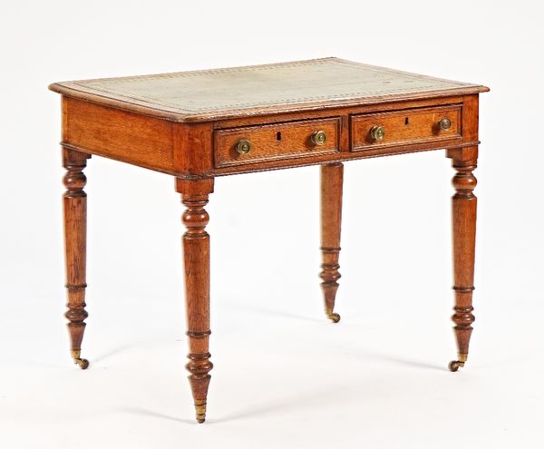 An early Victorian oak two drawer writing desk, on turned supports, 91cm wide x 74cm high.