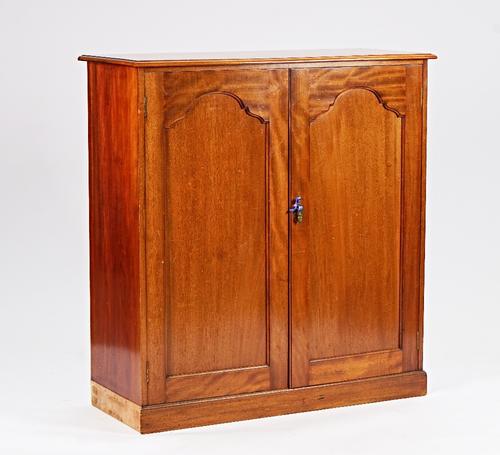 A George III style mahgoany side cabinet, the arch panel doors enclosing a fitted interior, on plinth base, 116cm wide x 123cm high.