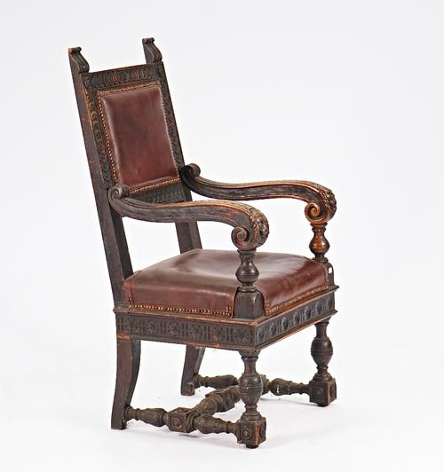 A 19th century Continental walnut open armchair with square back and beast head finials, on block and turned supports, 62cm wide x 120cm high.