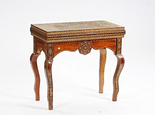 An early 20th century Middle Eastern extensively parquetry inlaid fold-over games table.