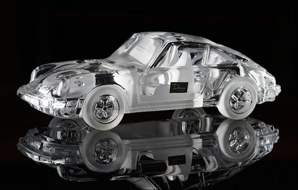 A Daum crystal model of a Porsche 911 Carrera, first produced in 1987, designed by Xavier Froissart, etched  Daum France and with paper label, 31cm....