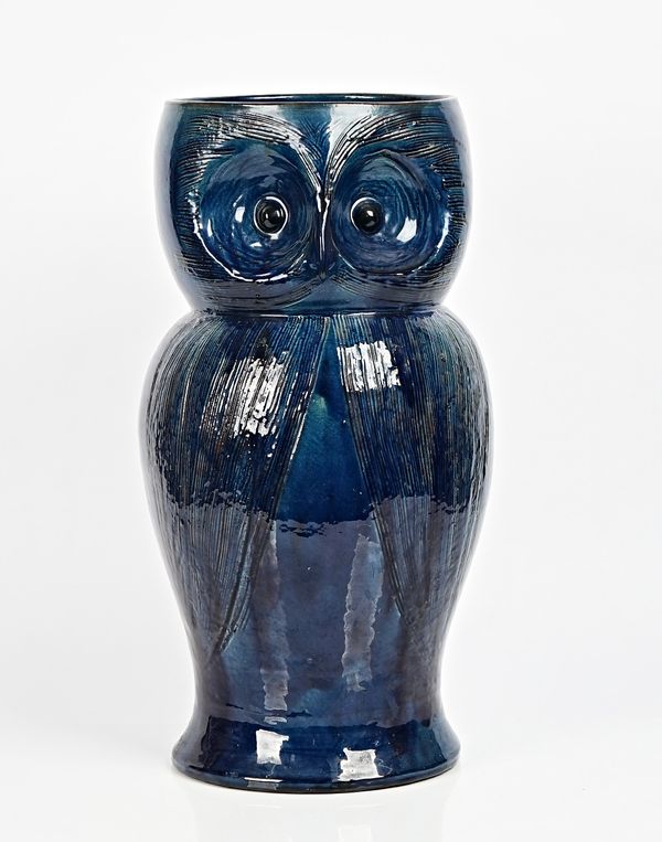 A rare Farnham Pottery owl umbrella stand, early 20th century, with incised decoration and covered in a deep blue glaze, incised X to base, 53cm....