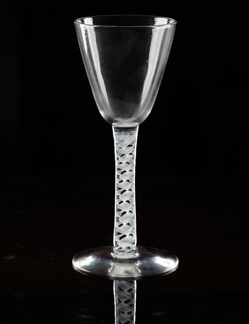 An opaque twist wine glass, circa 1920s, in 18th century style, the rounded funnel bowl raised on a double-series opaque twist stem and plain foot,...