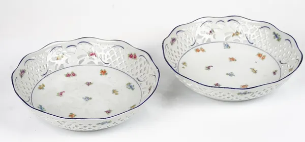 A pair of Schumann, Bavaria, circular pierced bowls, 20th  century, each painted with flowers beneath floral and basket pierced sides, blue printed...