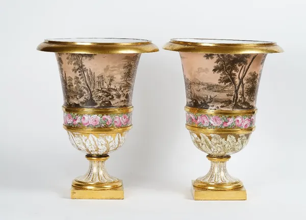A large pair of Paris porcelain campana vases, late 18th century, each painted en grisaille with a continuous landscape scene against a salmon pink...