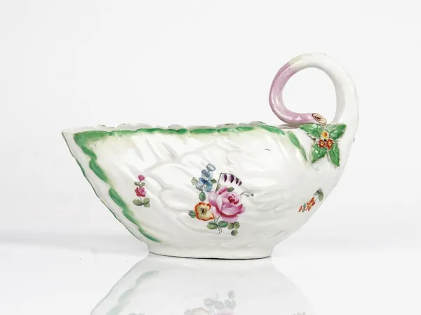 A Derby porcelain leaf moulded sauceboat, circa 1760-65, painted with scattered flowers, set with a stalk handle with bud and flowerhead terminals,...