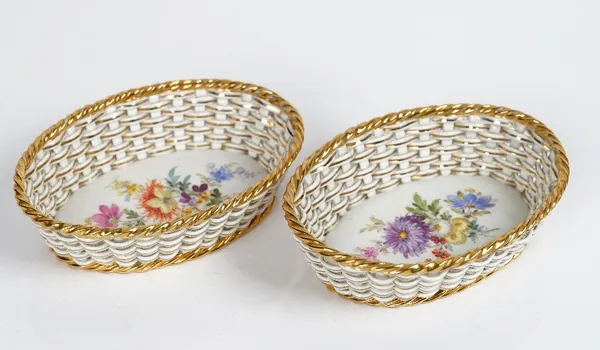 A pair of small Meissen pierced oval baskets,  early 20th century, each painted to the interior with flowers, blue crossed swords marks, 13.25cm....