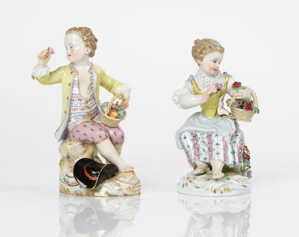 A pair of Meissen figures of a seated boy and girl holding baskets of flowers, late 19th century, blue crossed swords marks, incised 17,  12cm. high,...