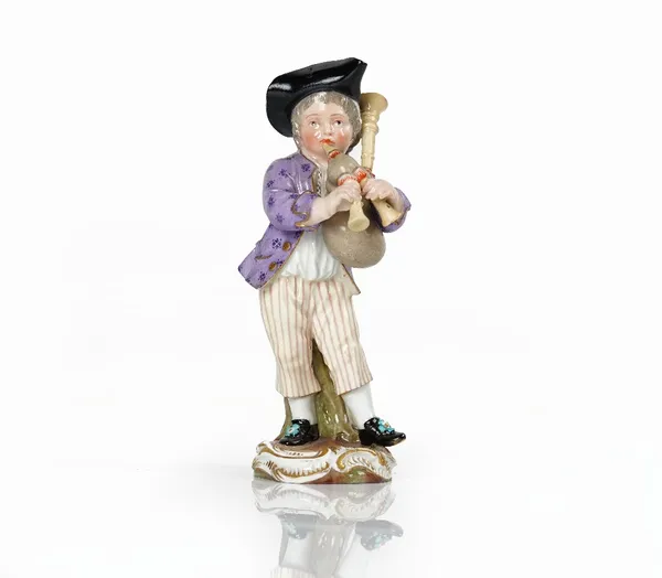 A Meissen figure of a boy playing the bagpipes, 19th century, standing wearing a black tricorn hat, blue crossed swords mark, impressed 119, 12.25cm....